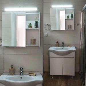 a bathroom with two sinks and a mirror at Sun & Sea : Malaki Seaside in Malaki