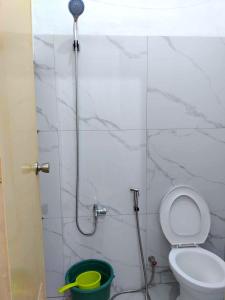 a bathroom with a shower with a toilet and a bucket at RM3 - Ground Floor Unit in San Roque Bauan Batangas in Batangas City