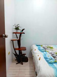 a bedroom with a table next to a bed at RM3 - Ground Floor Unit in San Roque Bauan Batangas in Batangas City