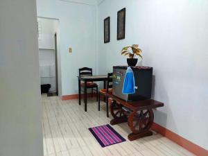 a room with a table and a tv on a table at RM3 - Ground Floor Unit in San Roque Bauan Batangas in Batangas City