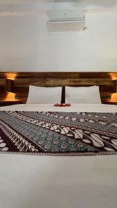 un letto con una coperta sopra di Marygio Gili Resort a Gili Trawangan