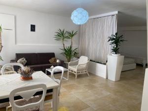 a living room with a couch and a table and chairs at Dimora al Mare in Villanova di Ostuni