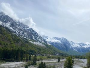 a view of a mountain range with snow at Guesthouse Mountain in Valbonë