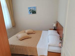 a bedroom with a bed with two pillows on it at Sirman Apart Hotel in Sarigerme