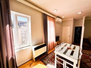 a bedroom with a white bed and a window at "STAIRS"guest house in Yerevan