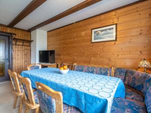 a dining room with a blue table and chairs at Quietly situated group house in the southern Black Forest with a gorgeous view in Todtmoos