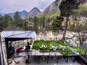 an aerial view of a park with tables and chairs at Delhi Height Kasol - Cafe and Hotel in Kasol