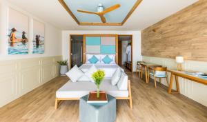 a living room with a couch and a table at Fusion Suites Vung Tau in Vung Tau