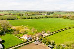 an aerial view of a large green field with a house at The Loft - Rural setting with parking in Bishop Monkton