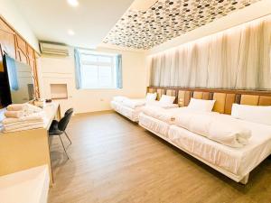 Postel nebo postele na pokoji v ubytování 綠島海灣會館Bay Resort