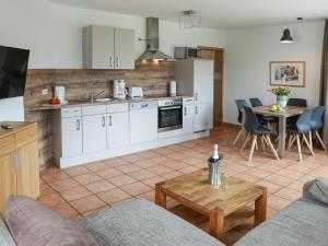 a kitchen and living room with a couch and a table at Magnificent Apartment in Willingen with Balcony in Willingen
