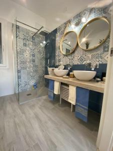 La salle de bains est pourvue de 2 lavabos et d'un miroir. dans l'établissement Charming #targaflorio apartment, fully equipped, à Campofelice di Roccella