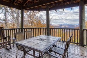 - une table et des chaises sur une terrasse avec vue dans l'établissement Mountain Bliss: Estate w/ Views~FirePit~Hot Tub~Gburg 5min~3 Pools, à Gatlinburg 46 autres photos