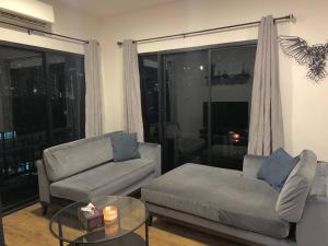 a living room with a couch and a coffee table at Room 36 Serviced Appartment - Skyline View in Bangkok