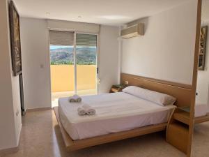 a bedroom with a bed with two towels on it at Bitacora VI Solo Familias SERVIPLAYA in Playa de Gandia +10 photos