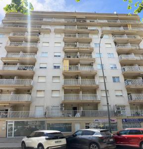two cars parked in front of a building at Bitacora VI Solo Familias SERVIPLAYA in Playa de Gandia