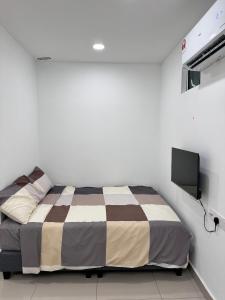 a bedroom with a bed and a flat screen tv at Famosa 2 Stay at Ong Kim Wee in Melaka +29 photos