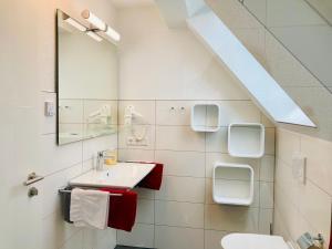 a bathroom with a sink and a mirror at Pension Busch in Salem +30 photos