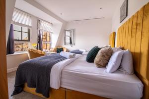 a bedroom with a large bed with pillows on it at Marble Arch Penthouse 1 Bed in London