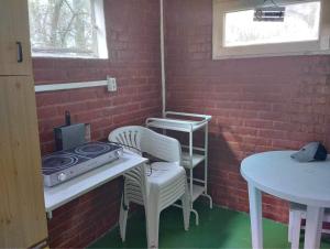 a room with a table and chairs and a stove at Top Nyaraló Mindszent in Mindszent
