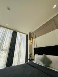 a bedroom with a bed and a large window at RL Boutique Dalat in Da Lat