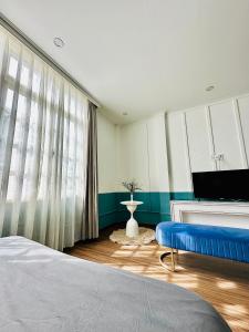 a bedroom with a bed and a tv and a window at RL Boutique Dalat in Da Lat +29 photos