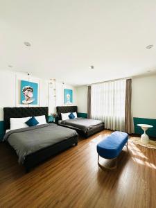 a bedroom with two beds and a ottoman at RL Boutique Dalat in Da Lat