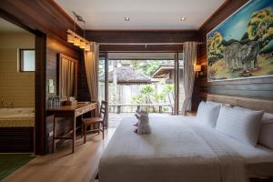 a bedroom with a large bed and a bathroom at GajaPuri Resort Koh Chang in Ko Chang +137 photos