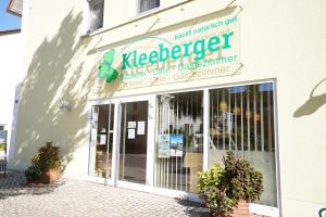 a store with a sign on the side of a building at Gästehaus Kleeberger in Pleinfeld