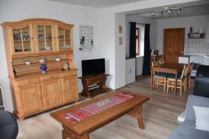 a living room with a couch and a table at Akác Tanya in Alsómóricgát