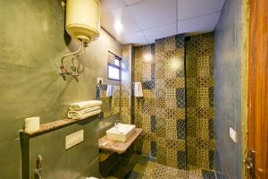 y baño con lavabo y ducha. en Balwood Suites Near Delhi Airport, en Nueva Delhi