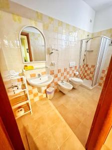a bathroom with a sink and a toilet and a shower at Colledisisto Guest House & Restaurant in Pomarico +46 photos