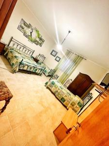 a living room with two beds and a couch at Colledisisto Guest House & Restaurant in Pomarico