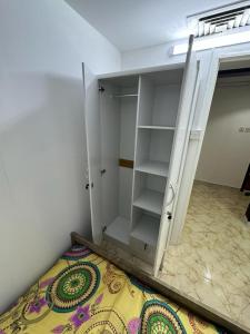a bedroom with a bed and a closet with a mirror at Al Majaz Partition & Rooms in Sharjah