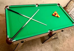 a pool table with balls on top of it at Detached Home with Aircon, Patio, BBQ, Pool Table & Table Tennis in Quinton
