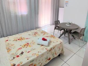 a room with a bed and a table and a table and chairs at JACY AP GOSTOSO in São Miguel do Gostoso