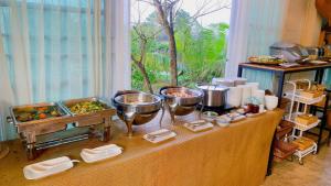 a buffet of food on a table in a room at Pupah Kanna Pua-ปู๋ ป๋าล์ คันนา ปัว in Pua