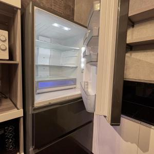 an empty refrigerator with its door open in a kitchen at 遇見 雲山居 in Fuli