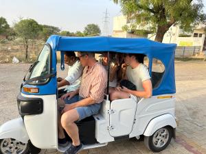 a group of people riding in a small golf cart at Dá Bungalow - A Vacation Abode in Agra