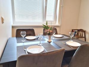 a dining room table with plates and glasses on it at Räpina Apartment in Räpina