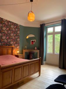 a bedroom with a bed and a window and a mirror at Domaine La Rose in Caylus