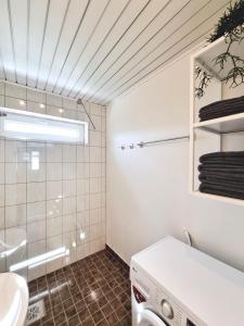 a bathroom with a sink and a washing machine at Räpina Apartment in Räpina
