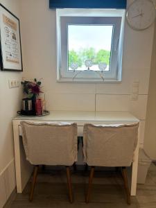 a table and two chairs under a window at Eco Overnight Inn 