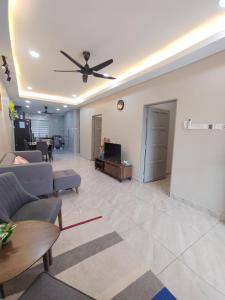 a living room with a couch and a ceiling fan at 5 Blossom Loveu Homestay in Seremban