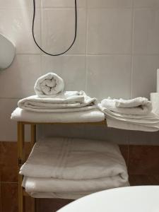 a pile of towels on a shelf in a bathroom at Civico 98 in Milazzo