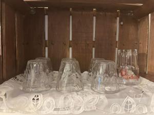 a table with four glass jars on a white table cloth at Civico 98 in Milazzo