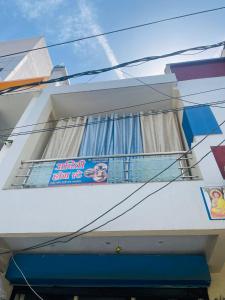 a building with a sign on the side of it at Aditi home stay in Ujjain