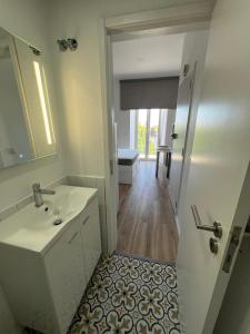 a bathroom with a sink and a mirror at Estrela da Almada Mascarenhas in Almada +102 photos