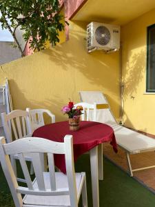 un tavolo con sedie e un ventilatore su un patio di Appartamenti al mare nel Salento a Torre Pali