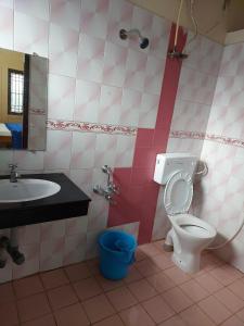 a bathroom with a toilet and a sink at Caron Niron Two Bedroom Villa in Kodaikānāl